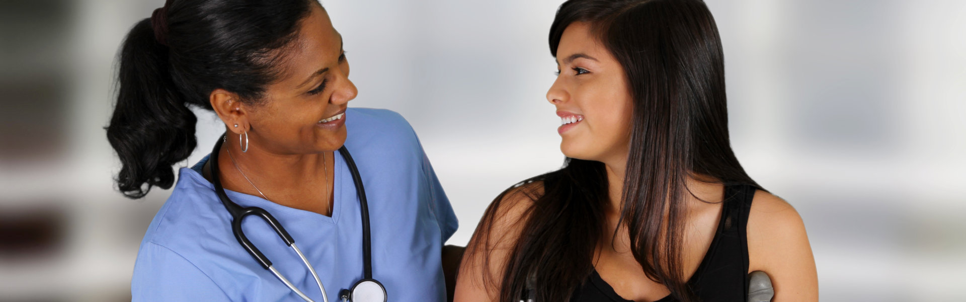 nurse and woman looking at each other