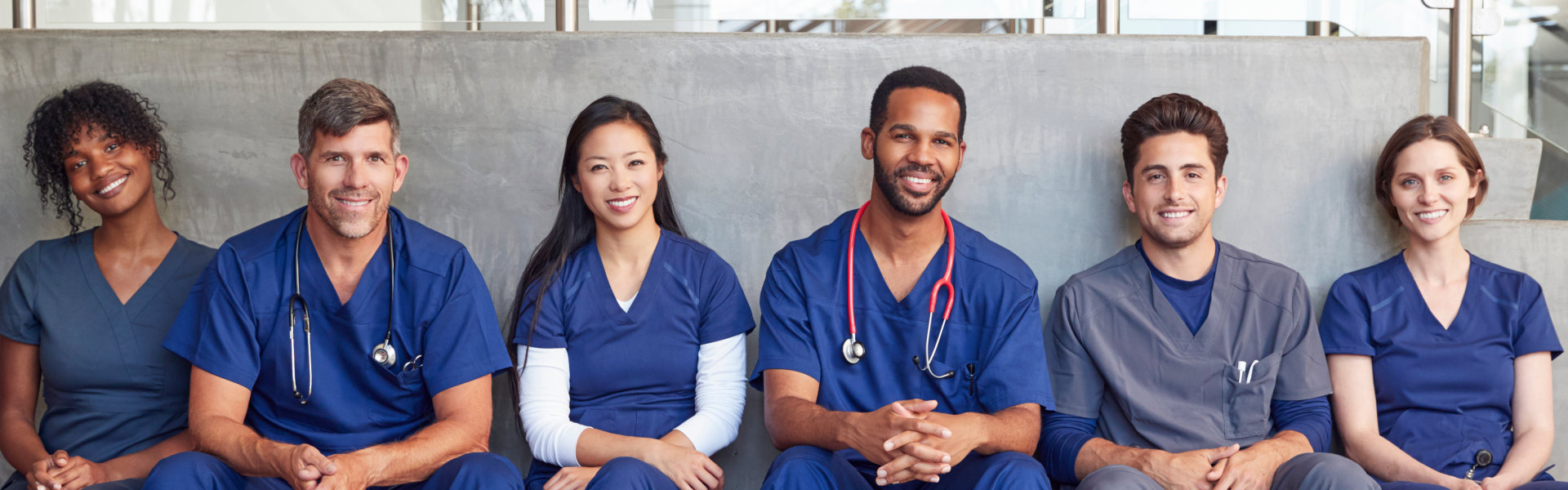 group of medical staff sitting and looking at the camera