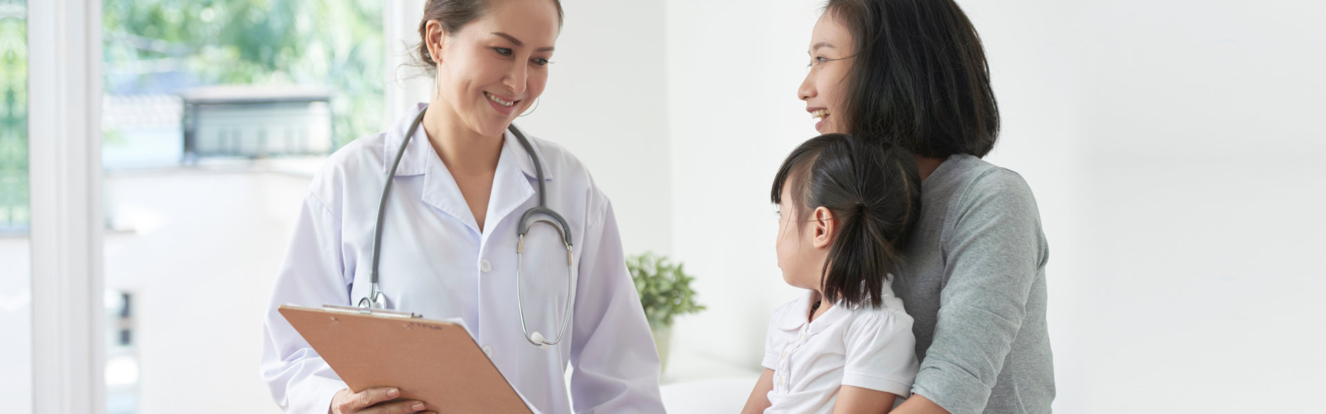 doctor checking up the kid with her mother