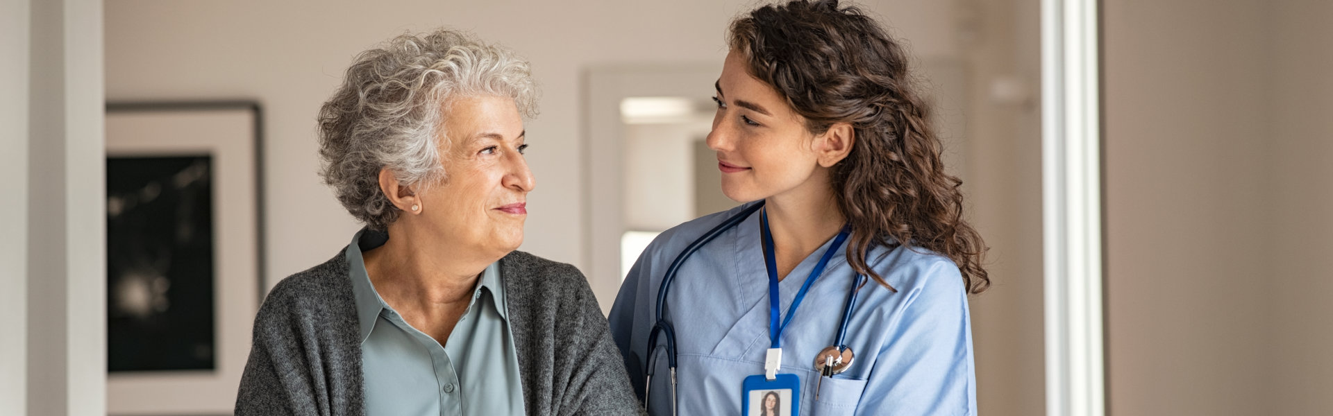 nurse assisting elderly woman